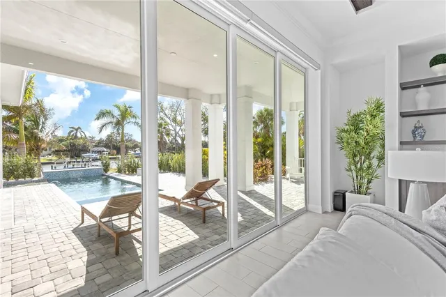 a living room with a floor to ceiling window and floor to ceiling window