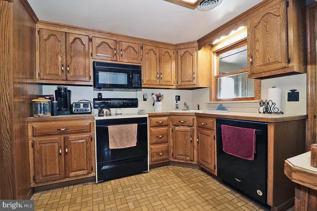 a kitchen with stainless steel appliances granite countertop a refrigerator sink and stove