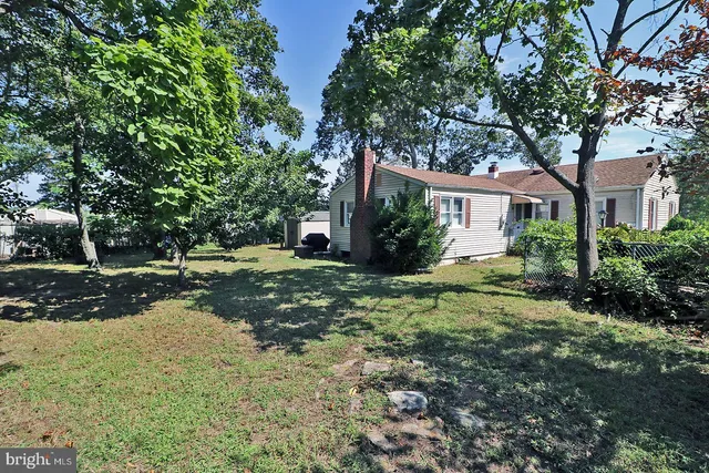 a view of a house with a tree in the yard