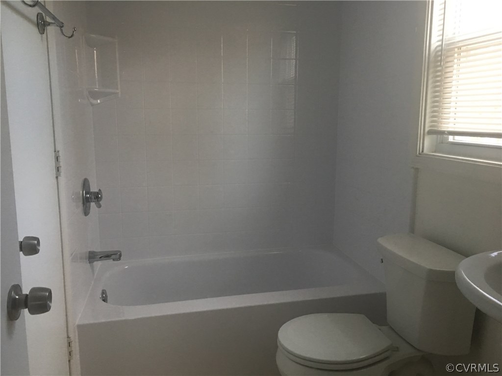 5253 Rollingway Road Chesterfield, VA 23832 - Photo 12 of 16 a white toilet and tub next to a window