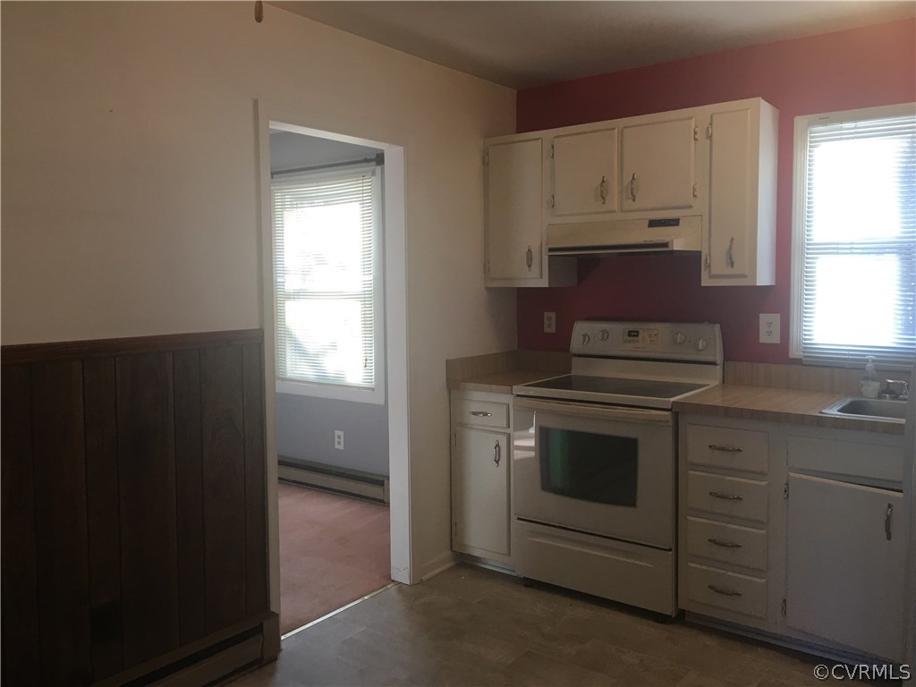 5253 Rollingway Road Chesterfield, VA 23832 - Photo 6 of 16 a kitchen with granite countertop white cabinets and appliances