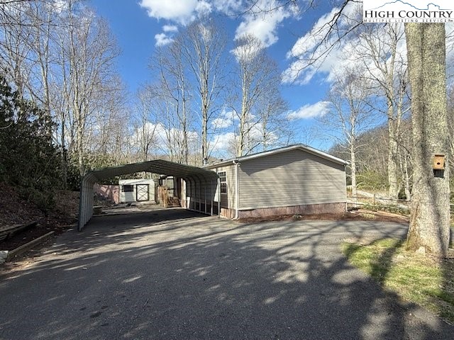 68 Rhoneys View Road Newland, NC 28657 - Photo 34 of 37 a view of a house with large trees