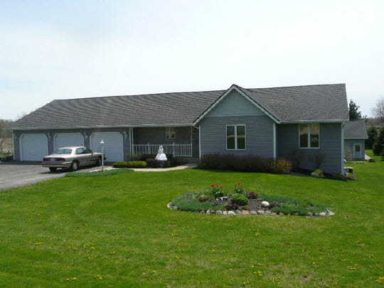 a front view of a house with a garden