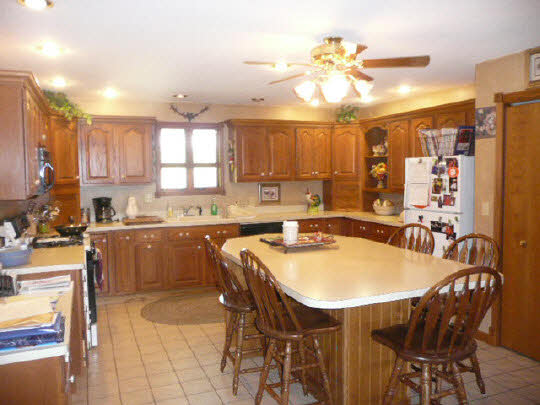 1965 East Water Road Byron, IL 61010 - Photo 5 of 11 a kitchen with a table chairs sink and cabinets