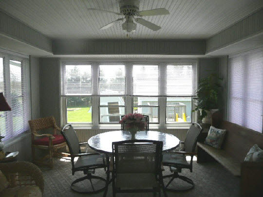 1965 East Water Road Byron, IL 61010 - Photo 7 of 11 a view of a dining room with furniture large windows and wooden floor