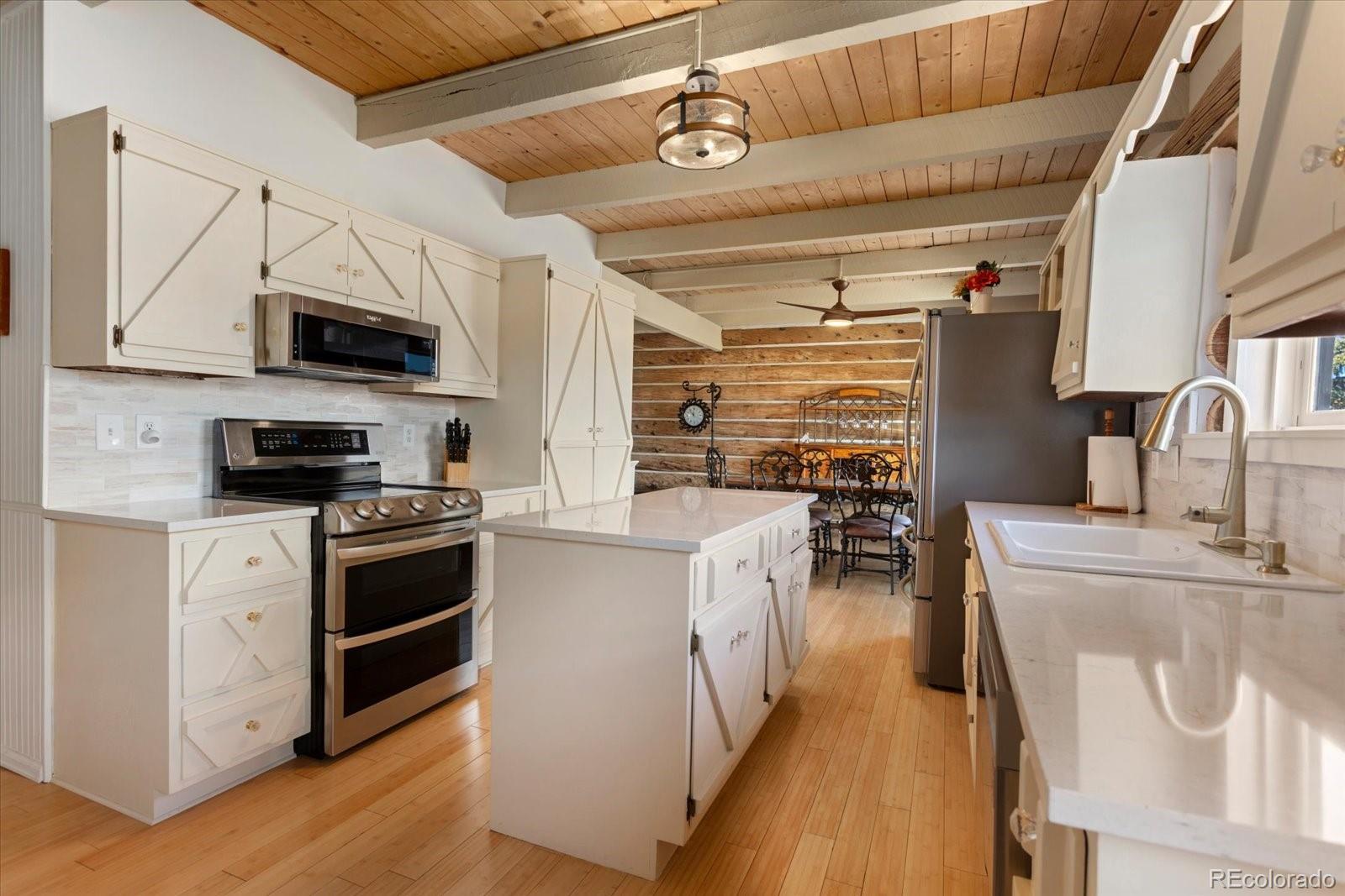 716 West Blarney Stone Road Howard, CO 81233 - Photo 12 of 50 a kitchen with stainless steel appliances granite countertop a stove and a refrigerator