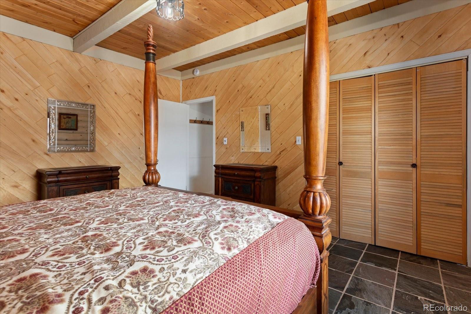 716 West Blarney Stone Road Howard, CO 81233 - Photo 14 of 50 a bedroom with a bed and a chandelier