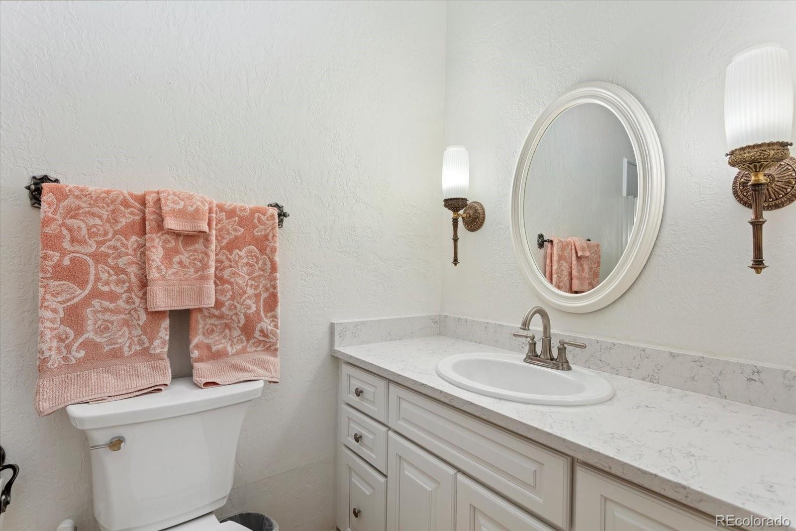 716 West Blarney Stone Road Howard, CO 81233 - Photo 15 of 50 a bathroom with a toilet sink and mirror