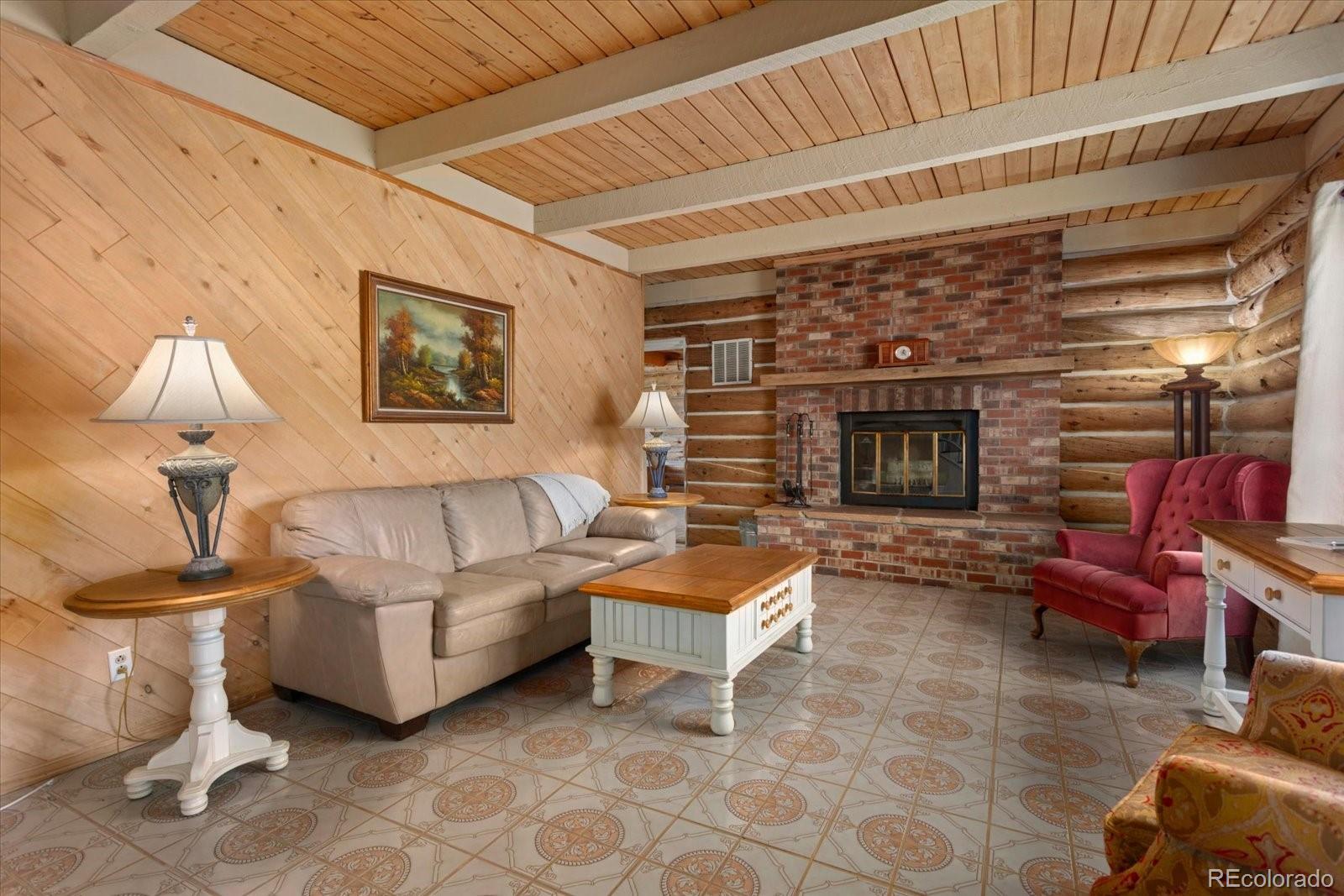 716 West Blarney Stone Road Howard, CO 81233 - Photo 17 of 50 a living room with furniture a fireplace and a table