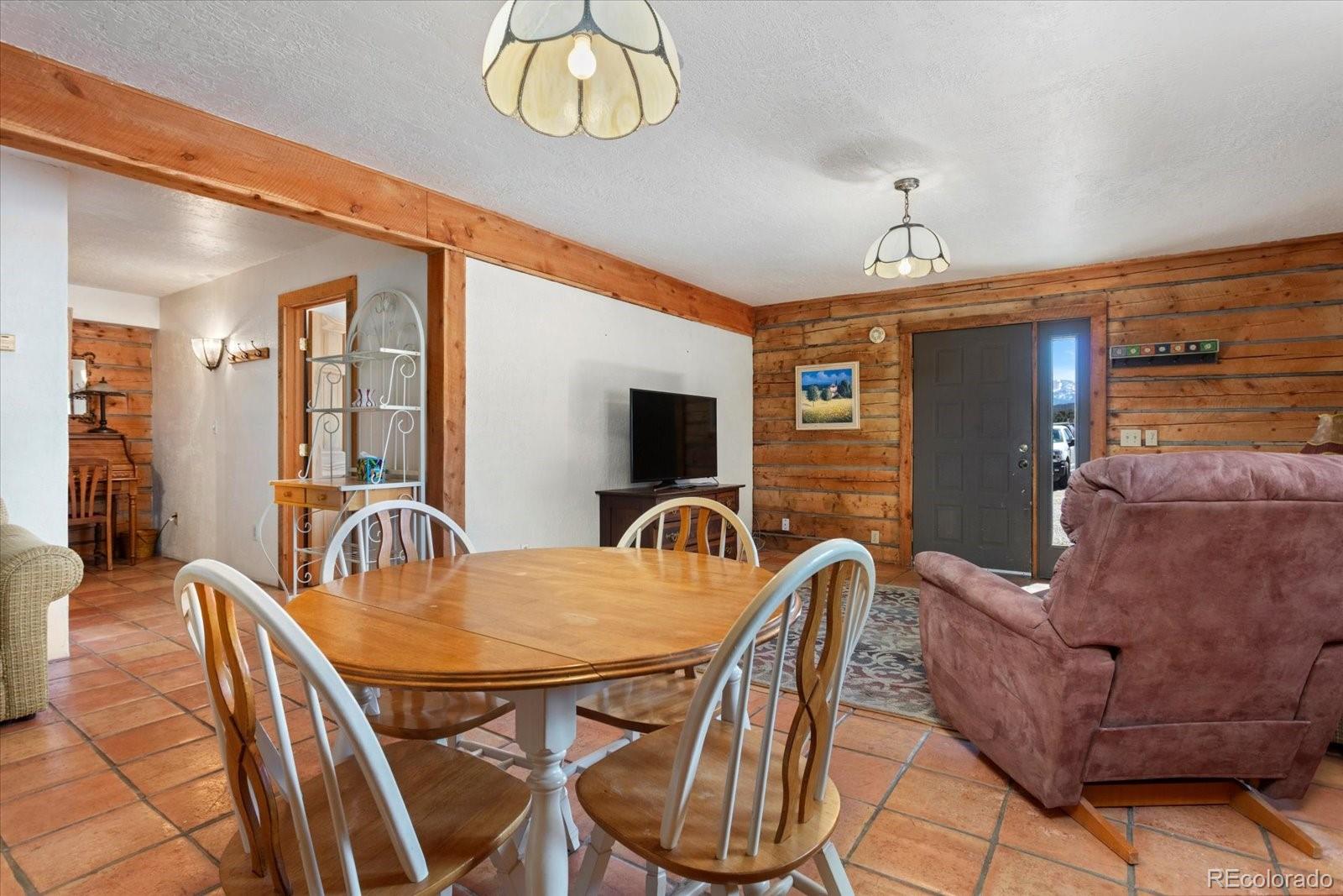 716 West Blarney Stone Road Howard, CO 81233 - Photo 35 of 50 a dining room with furniture and chandelier