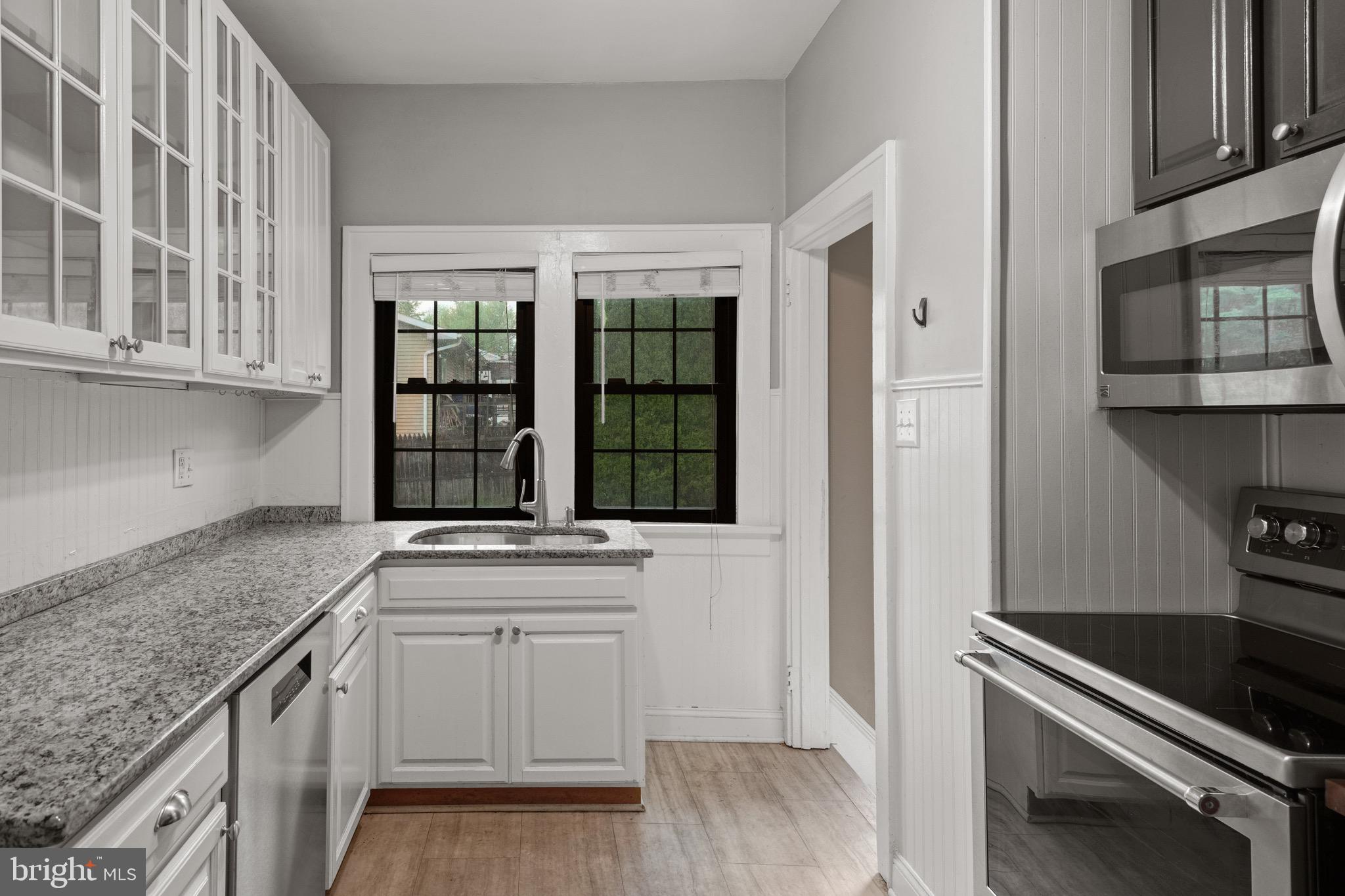 209 Ironstone Ridge Road Lancaster, PA 17603 - Photo 15 of 50 a kitchen with granite countertop a stove and a sink