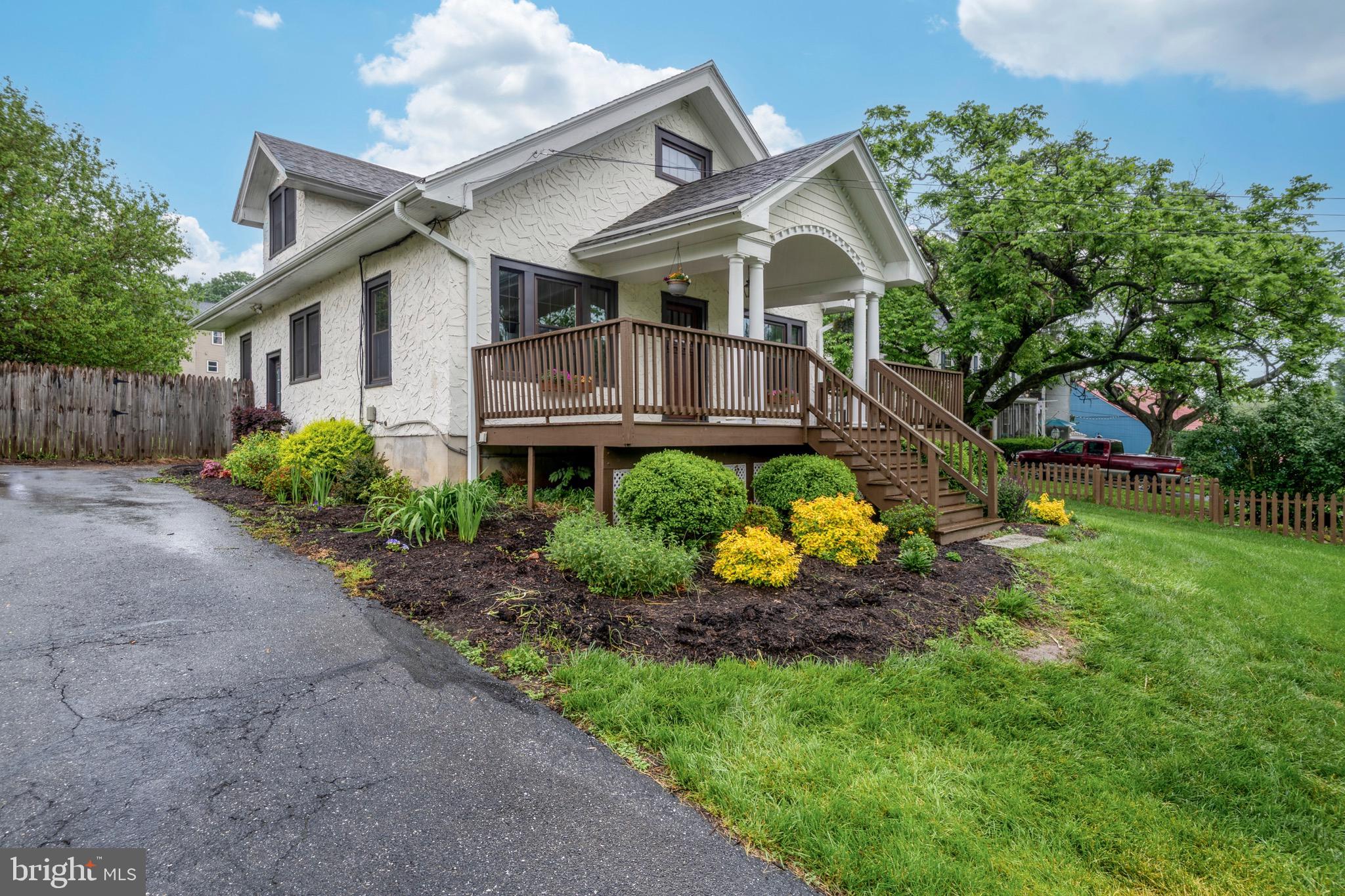 209 Ironstone Ridge Road Lancaster, PA 17603 - Photo 2 of 50 a front view of a house with a big yard and potted plants