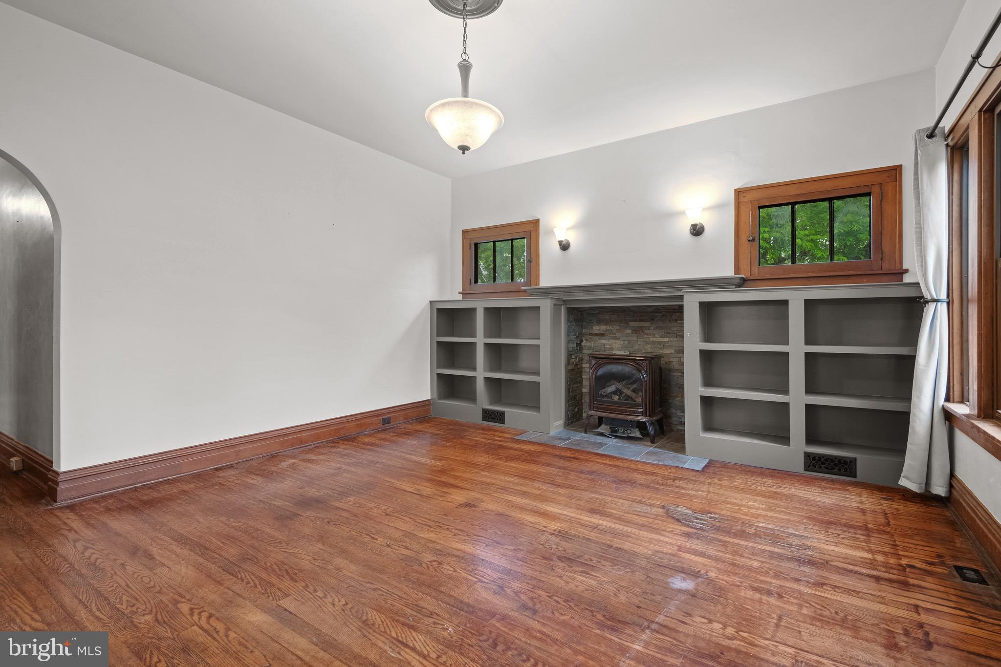 209 Ironstone Ridge Road Lancaster, PA 17603 - Photo 7 of 50 a view of an empty room with a fireplace and a window