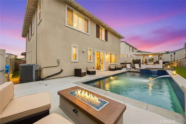 a view of a swimming pool with a chair and tables