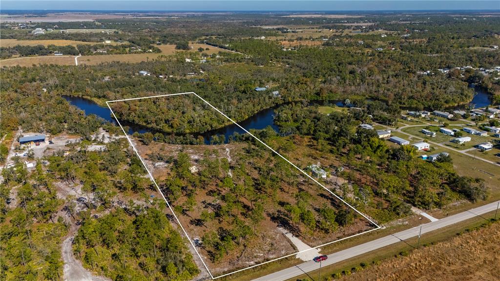 36051 Washington Loop Road Punta Gorda, FL 33982 - Photo 8 of 13 an aerial view of residential houses with outdoor space