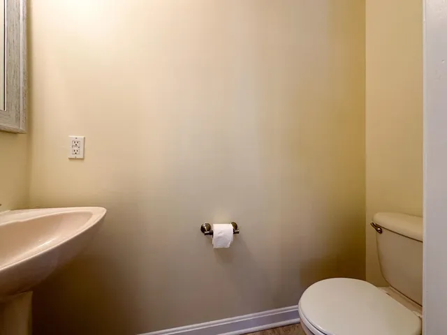 a bathroom with a white toilet and a sink