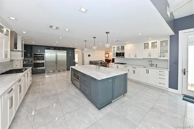 a dining room with furniture a chandelier and wooden floor