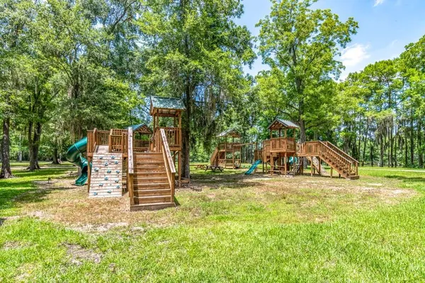 a view of a house with a yard and sitting area