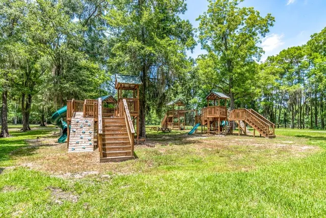 a view of a house with a yard and sitting area
