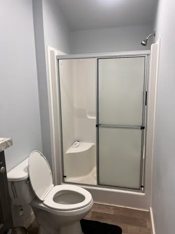 a bathroom with a toilet and a shower