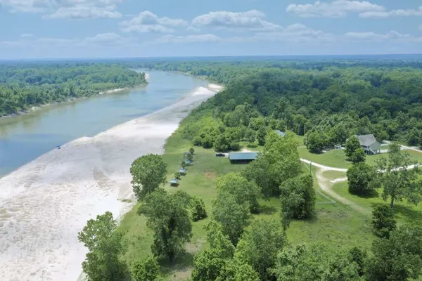 an aerial view of a houses with outdoor space and lake view