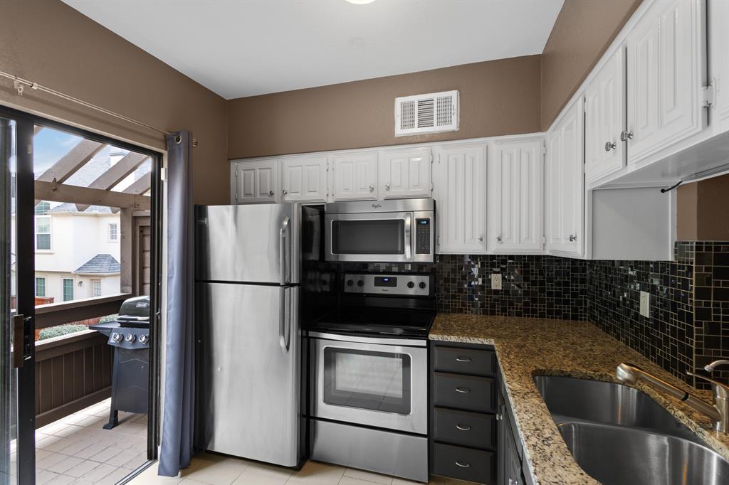 4130 Proton Drive, Unit 6D Addison, TX 75001 - Photo 11 of 38 a kitchen with a refrigerator sink and cabinets