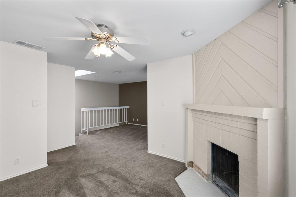 4130 Proton Drive, Unit 6D Addison, TX 75001 - Photo 19 of 38 a view of an empty room with chandelier fan and fire place