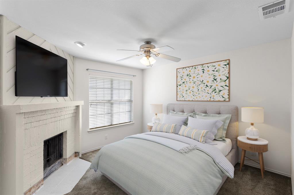4130 Proton Drive, Unit 6D Addison, TX 75001 - Photo 2 of 38 a bedroom with a large bed and a flat screen tv