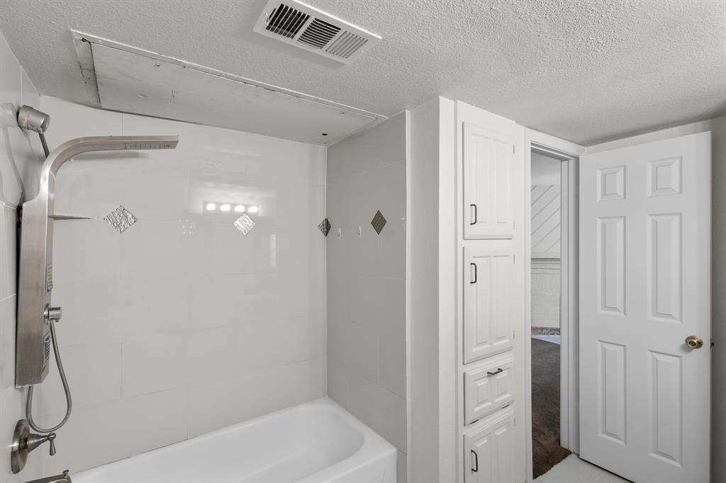 4130 Proton Drive, Unit 6D Addison, TX 75001 - Photo 21 of 38 a bathroom with a shower and a glass door