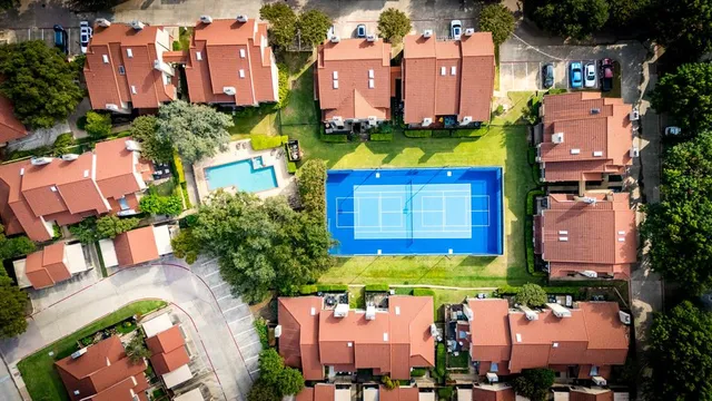 an aerial view of multiple houses with yard