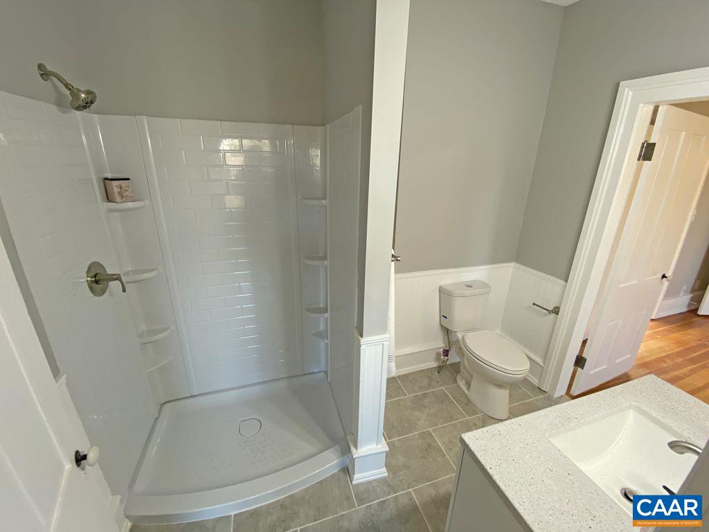 183 Summerdean Road Middlebrook, VA 24459 - Photo 23 of 36 a bathroom with a sink and a glass door shower