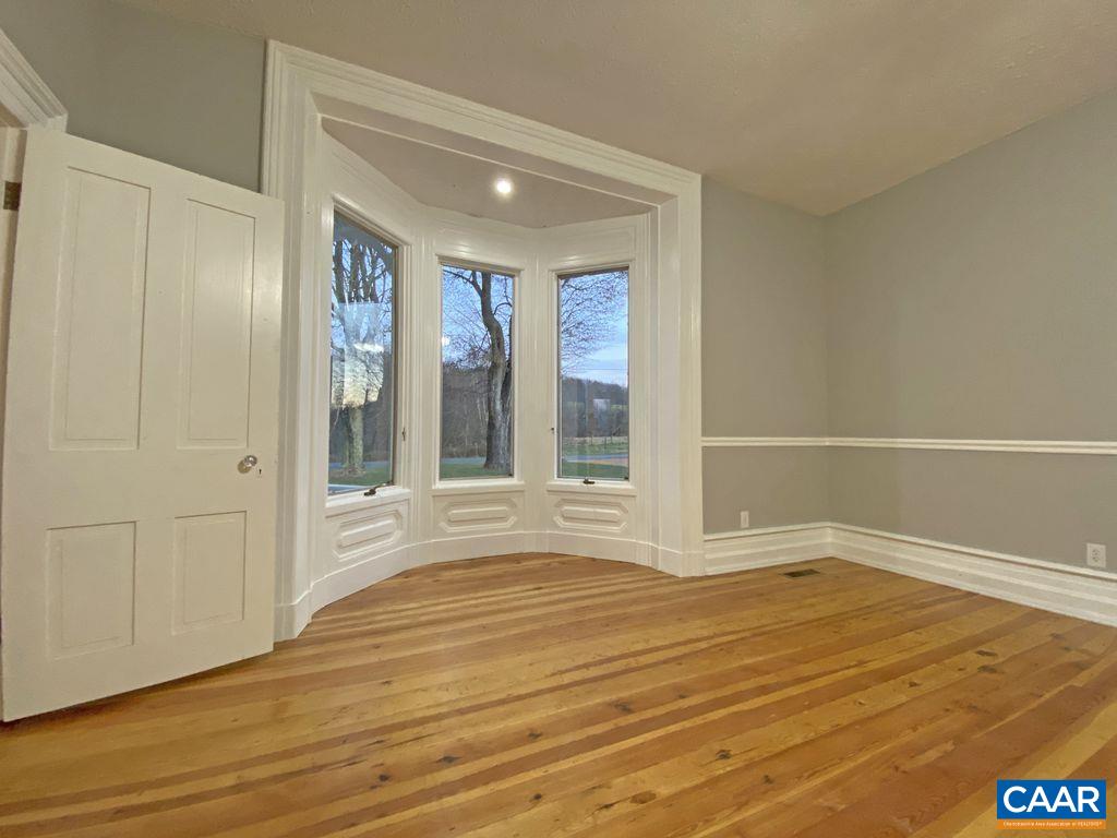 183 Summerdean Road Middlebrook, VA 24459 - Photo 8 of 36 a view of an empty room with wooden floor and a window