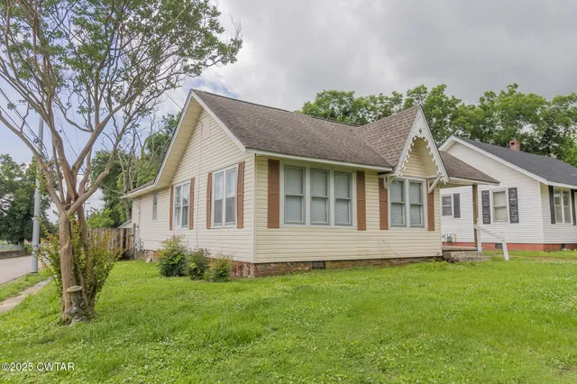 a front view of house with yard and green space