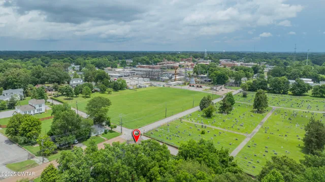 an aerial view of a houses with yard
