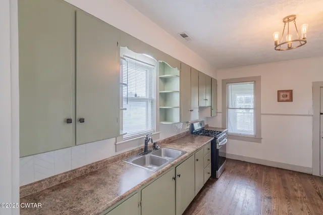 a bathroom with a granite countertop sink a large mirror and a bathtub