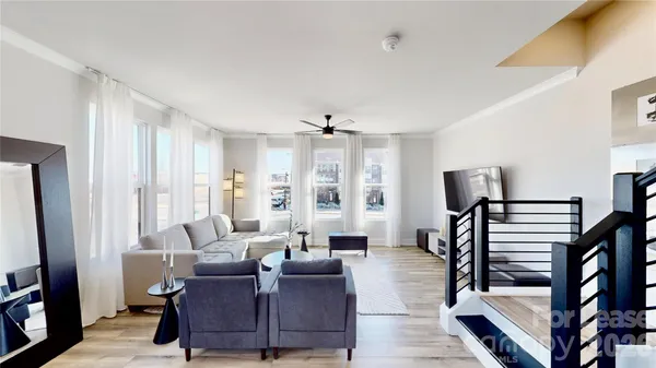 a living room with furniture and wooden floor