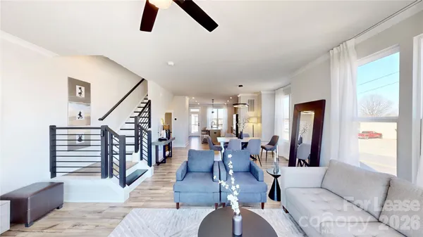 a living room with furniture and wooden floor