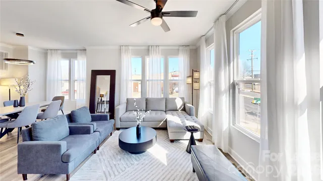 a living room with furniture and a large window