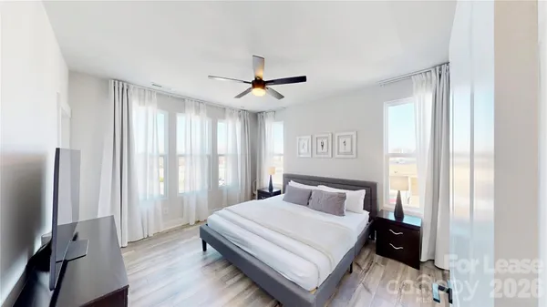 a bedroom with a large bed and a chandelier