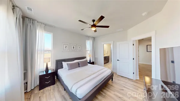 a bedroom with a bed and a large window