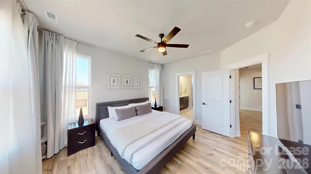 a bedroom with a bed and a large window