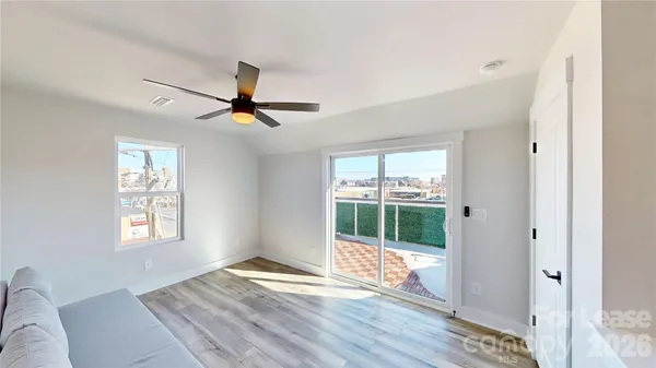a living room with hardwood floor and a window
