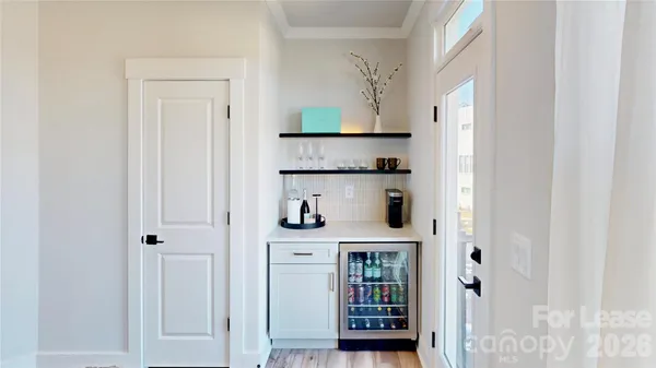 a kitchen with stainless steel appliances a refrigerator and a window