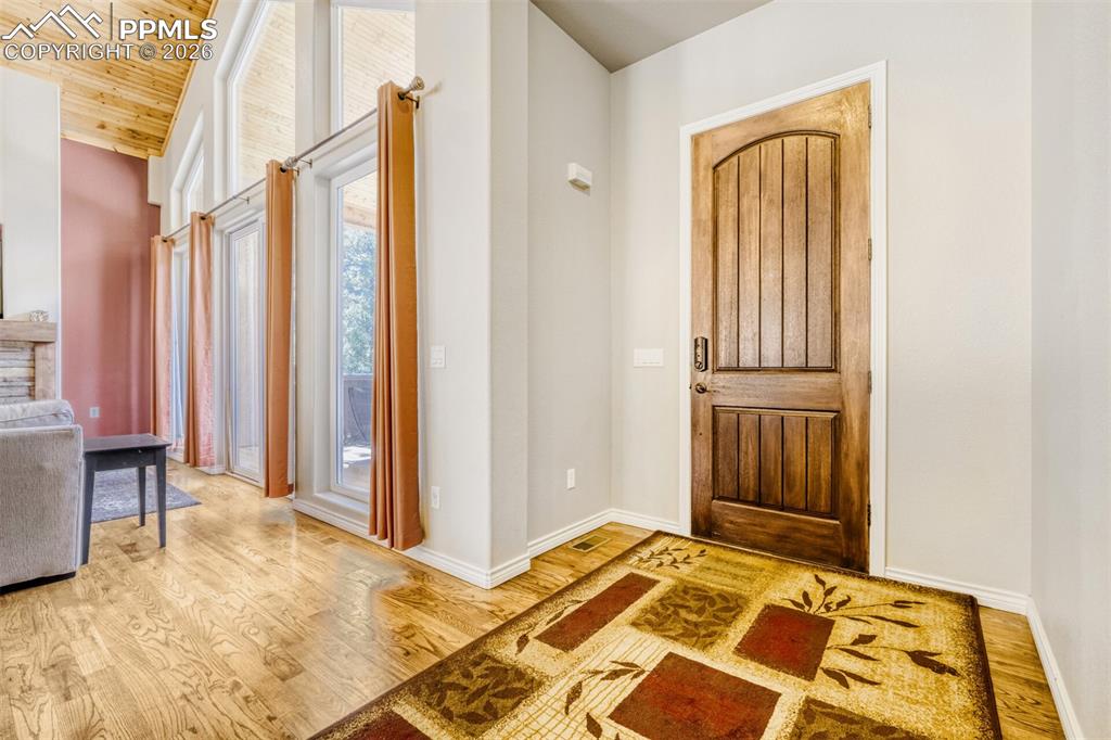 4519 Edwards Place Cascade, CO 80809 - Photo 4 of 47 Foyer with hardwood floors and wooden vaulted ceiling