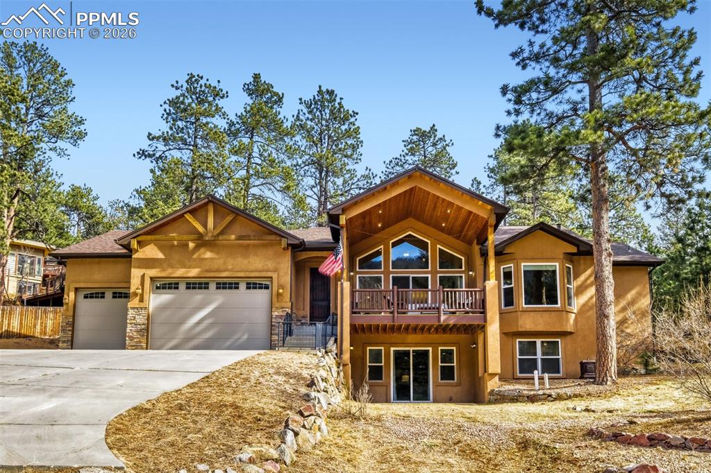 4519 Edwards Place Cascade, CO 80809 - Photo 47 of 47 View of front facade with a garage, driveway, stucco siding, and stone siding- the perfect mountain home retreat