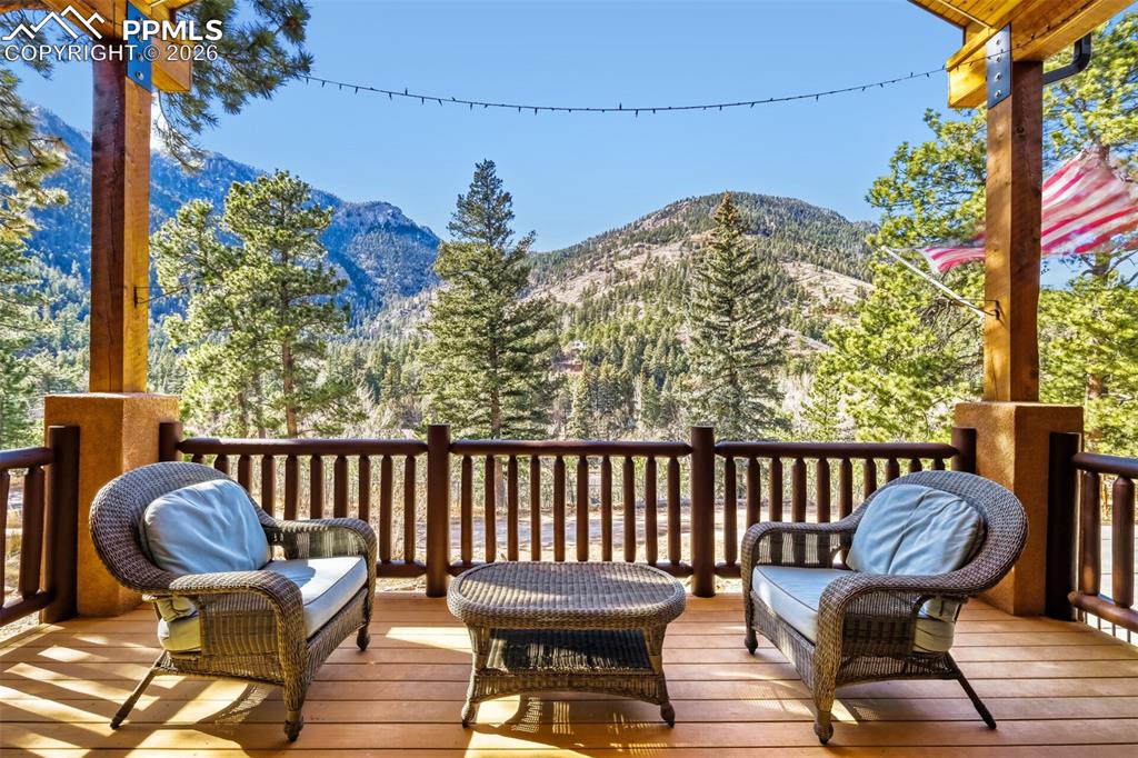 4519 Edwards Place Cascade, CO 80809 - Photo 9 of 47 Front covered deck featuring a mountain view