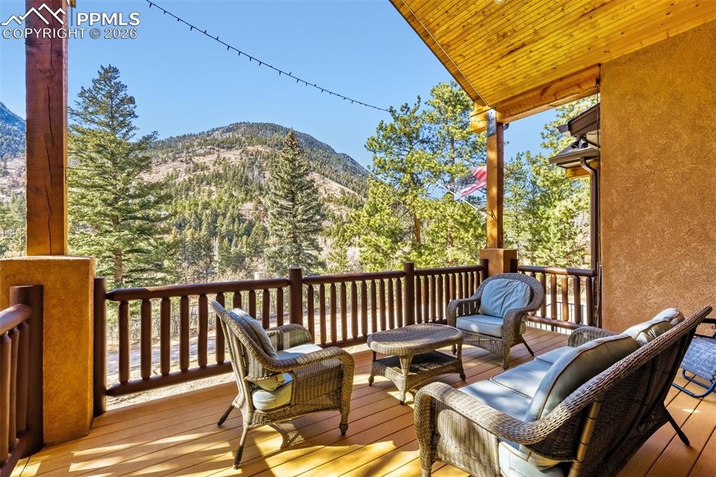 4519 Edwards Place Cascade, CO 80809 - Photo 10 of 47 Wooden deck featuring outdoor lounge area and a mountain view