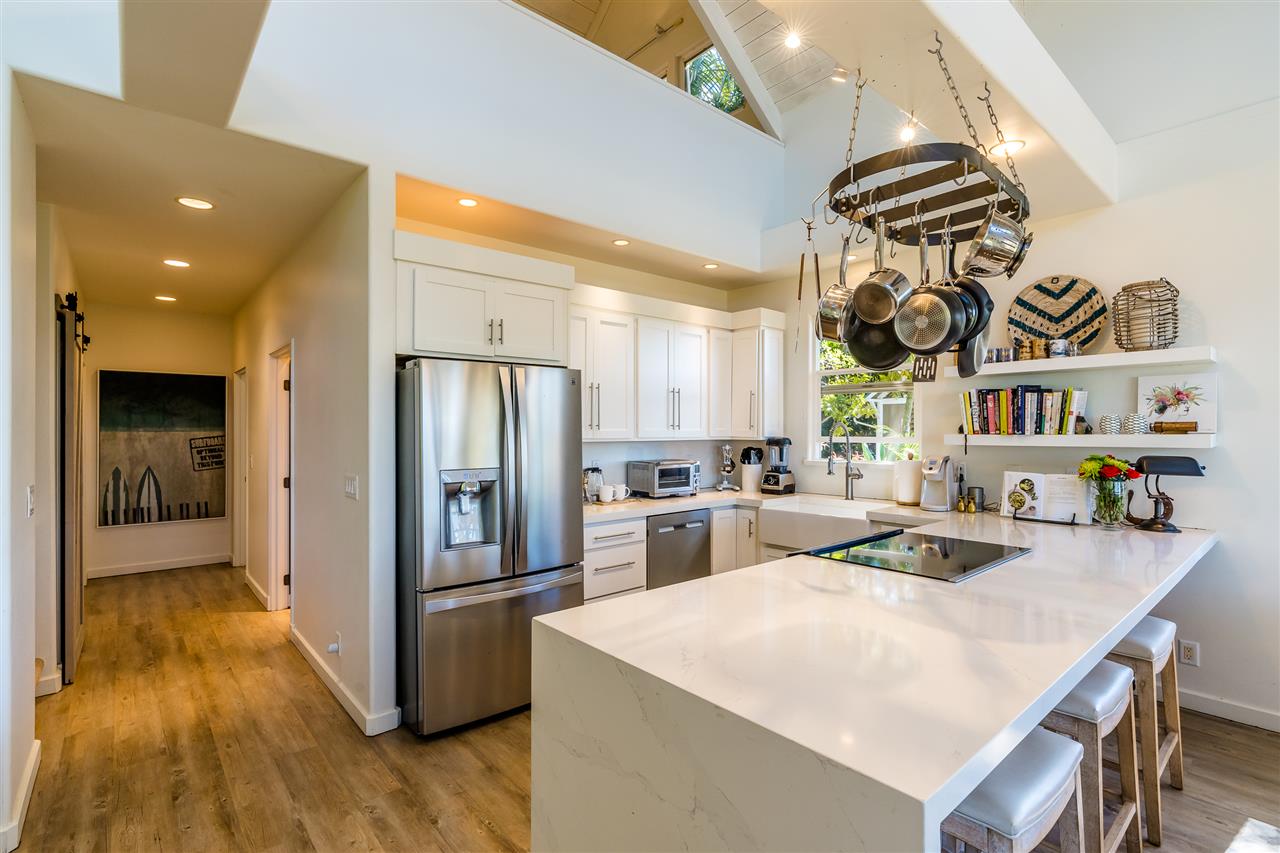 100 Laenani Street Haiku, HI 96708 - Photo 12 of 30 a kitchen with stainless steel appliances granite countertop a sink and a refrigerator