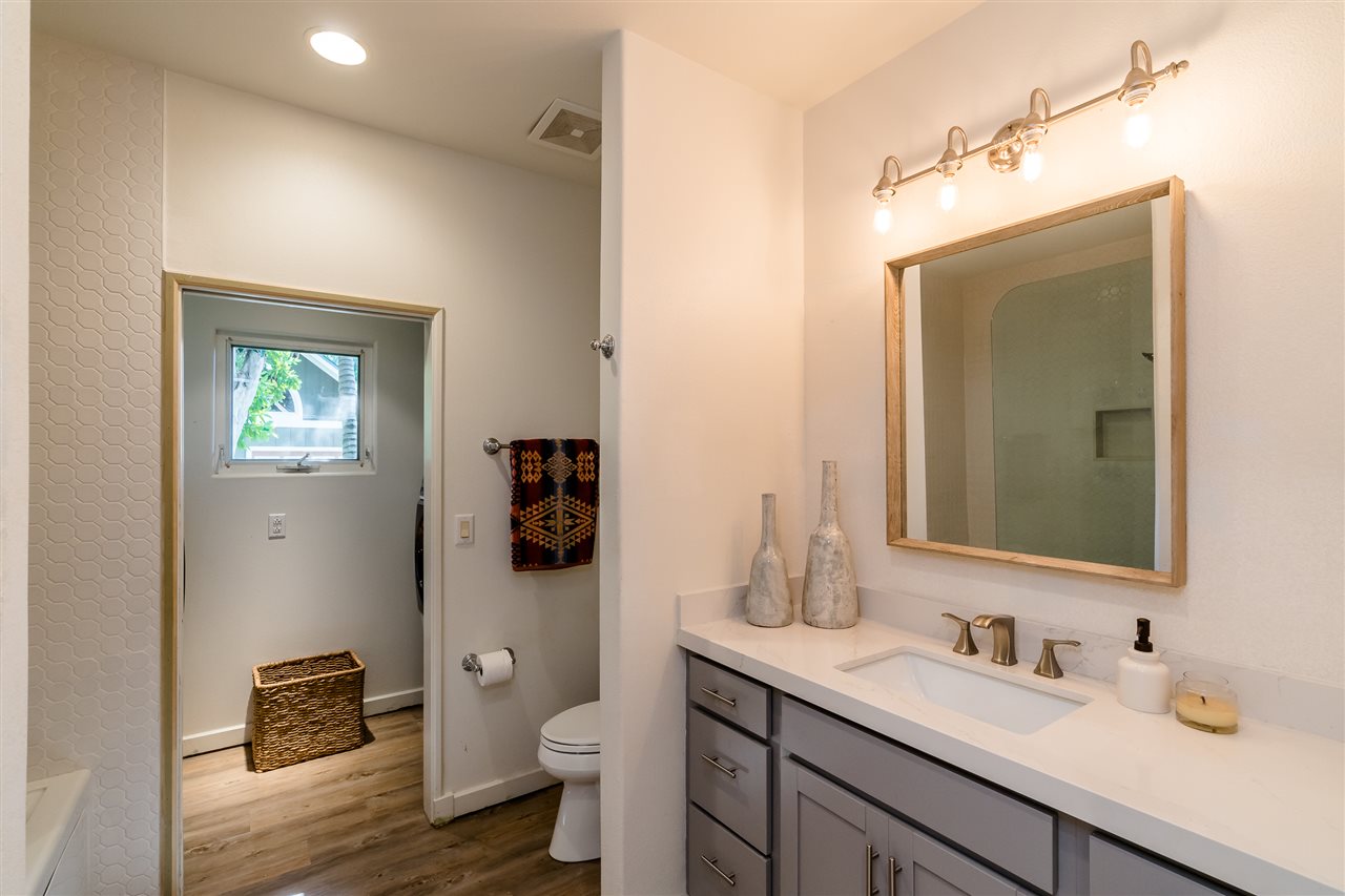 100 Laenani Street Haiku, HI 96708 - Photo 14 of 30 a bathroom with a toilet sink double vanity and mirror