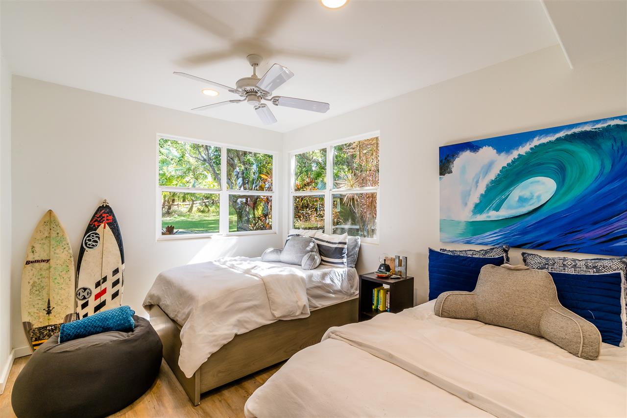 100 Laenani Street Haiku, HI 96708 - Photo 16 of 30 a bedroom with two beds and a window